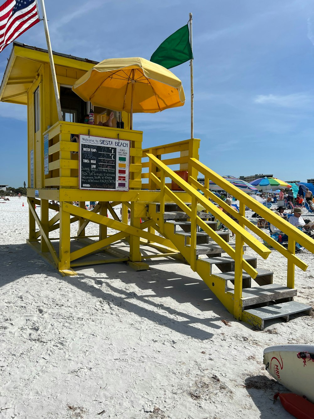 a lifeguard stand on the beach with an american flag