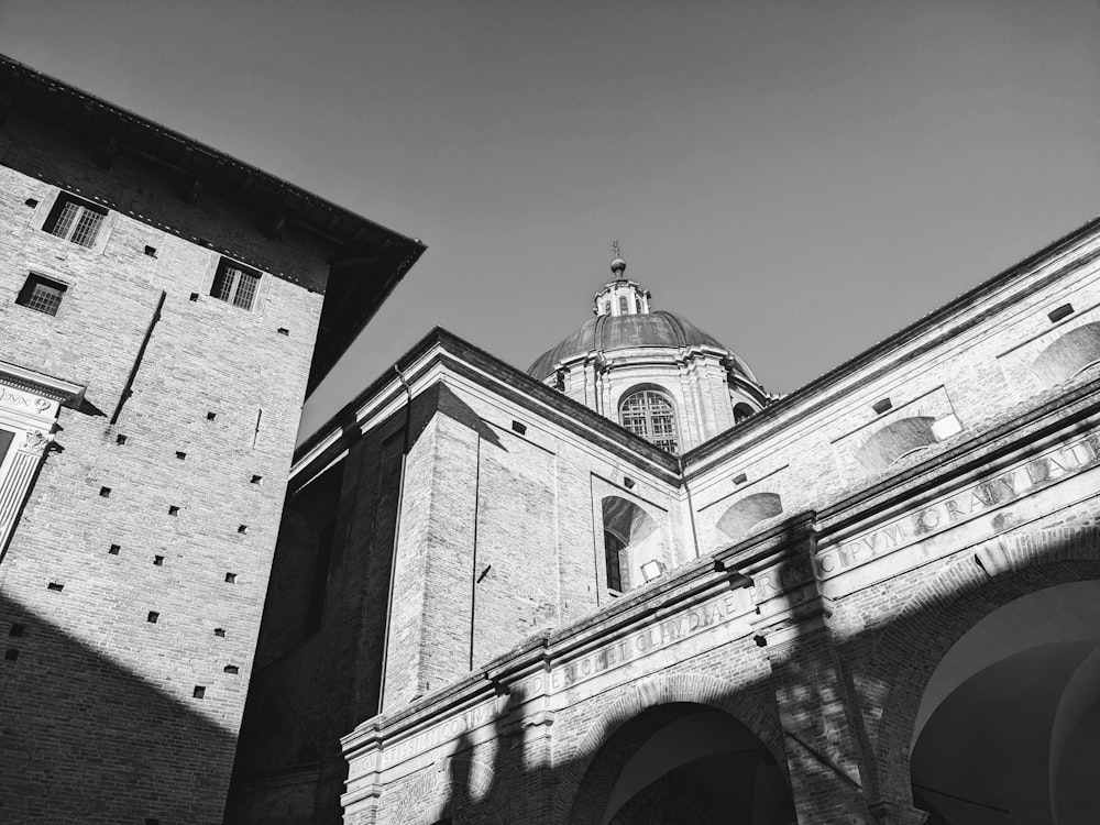 a black and white photo of a building with a clock tower