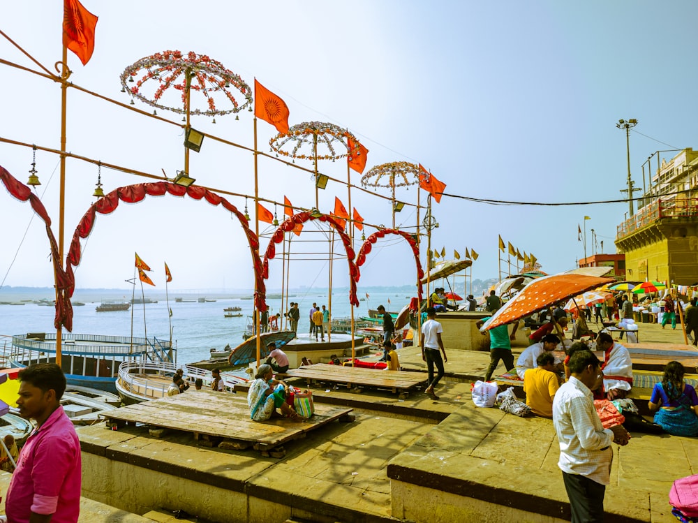 a group of people standing on top of a pier