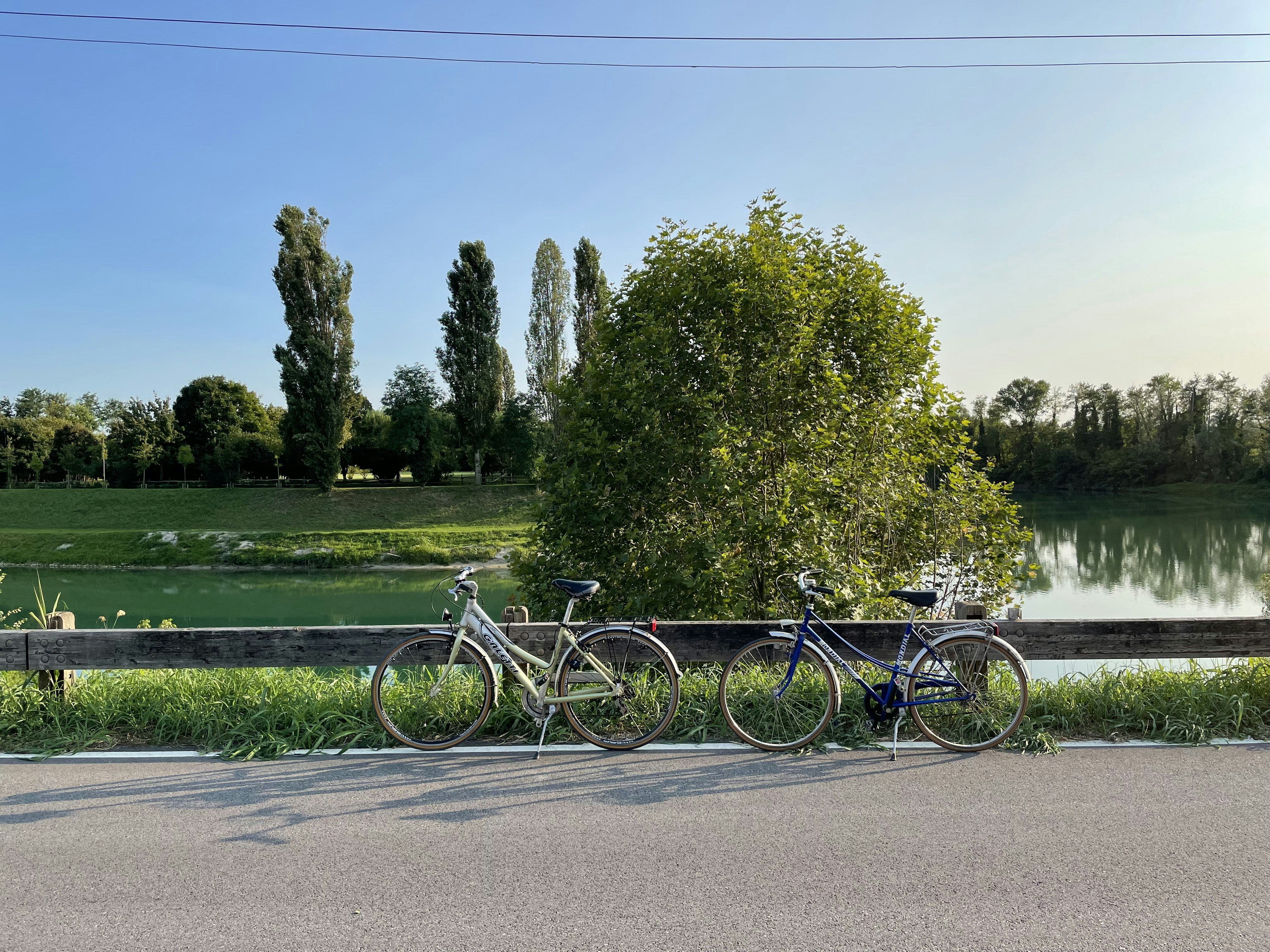 two bikes parked next to each other on the side of a road