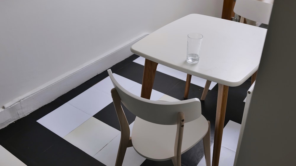 a white table and two chairs in a room