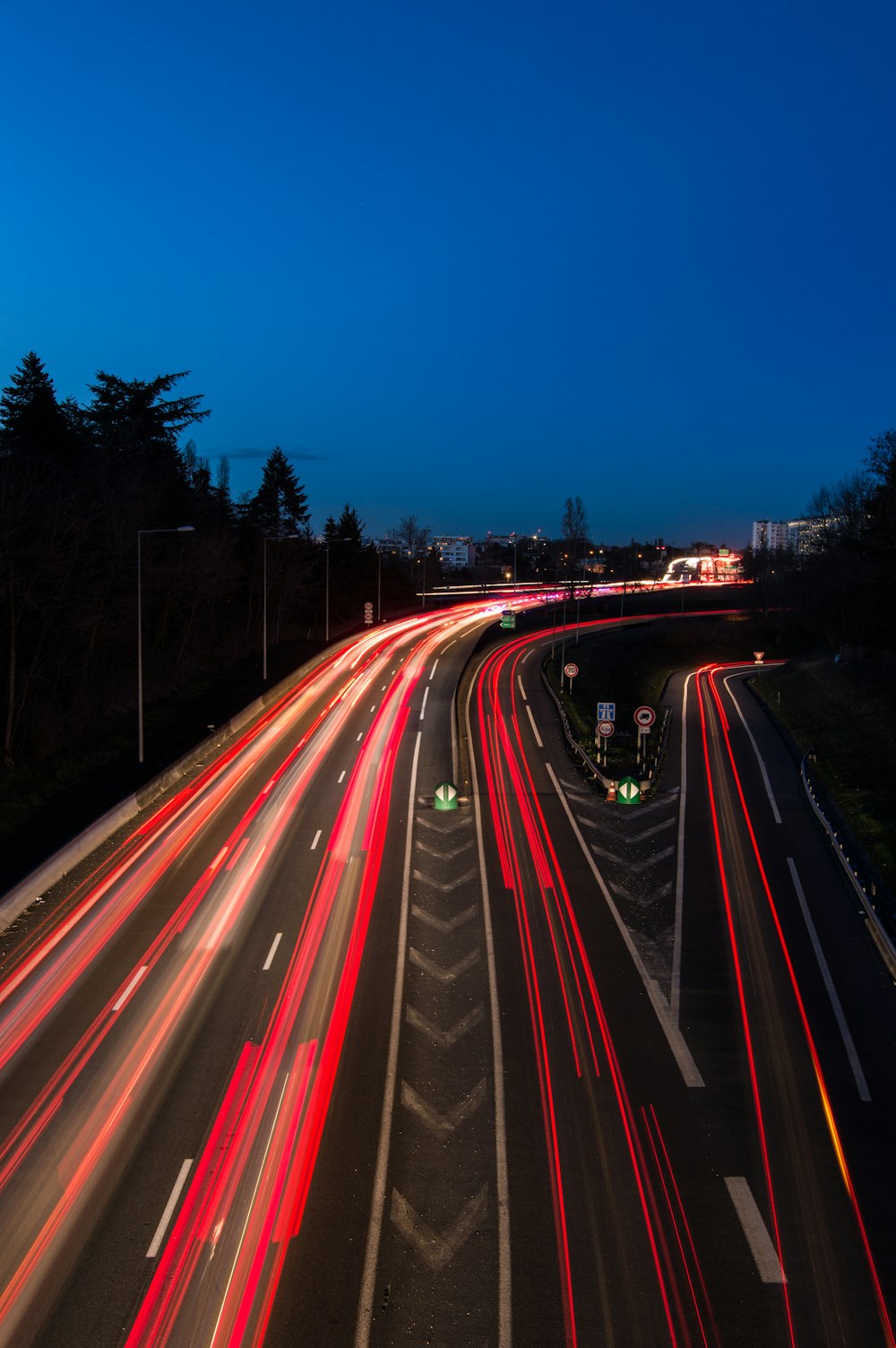 a long exposure photo of a highway at night