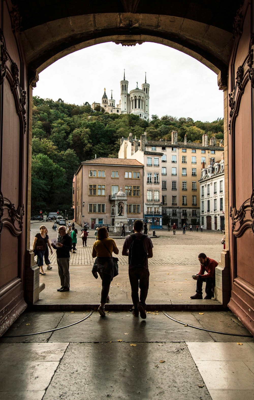 a group of people walking through an open doorway