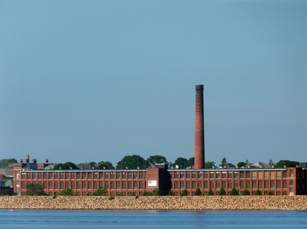 a large brick building next to a body of water