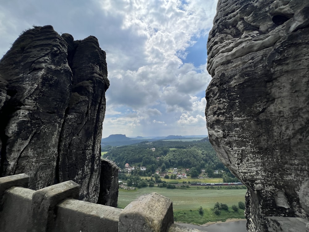 a scenic view of a valley and mountains from the top of a mountain