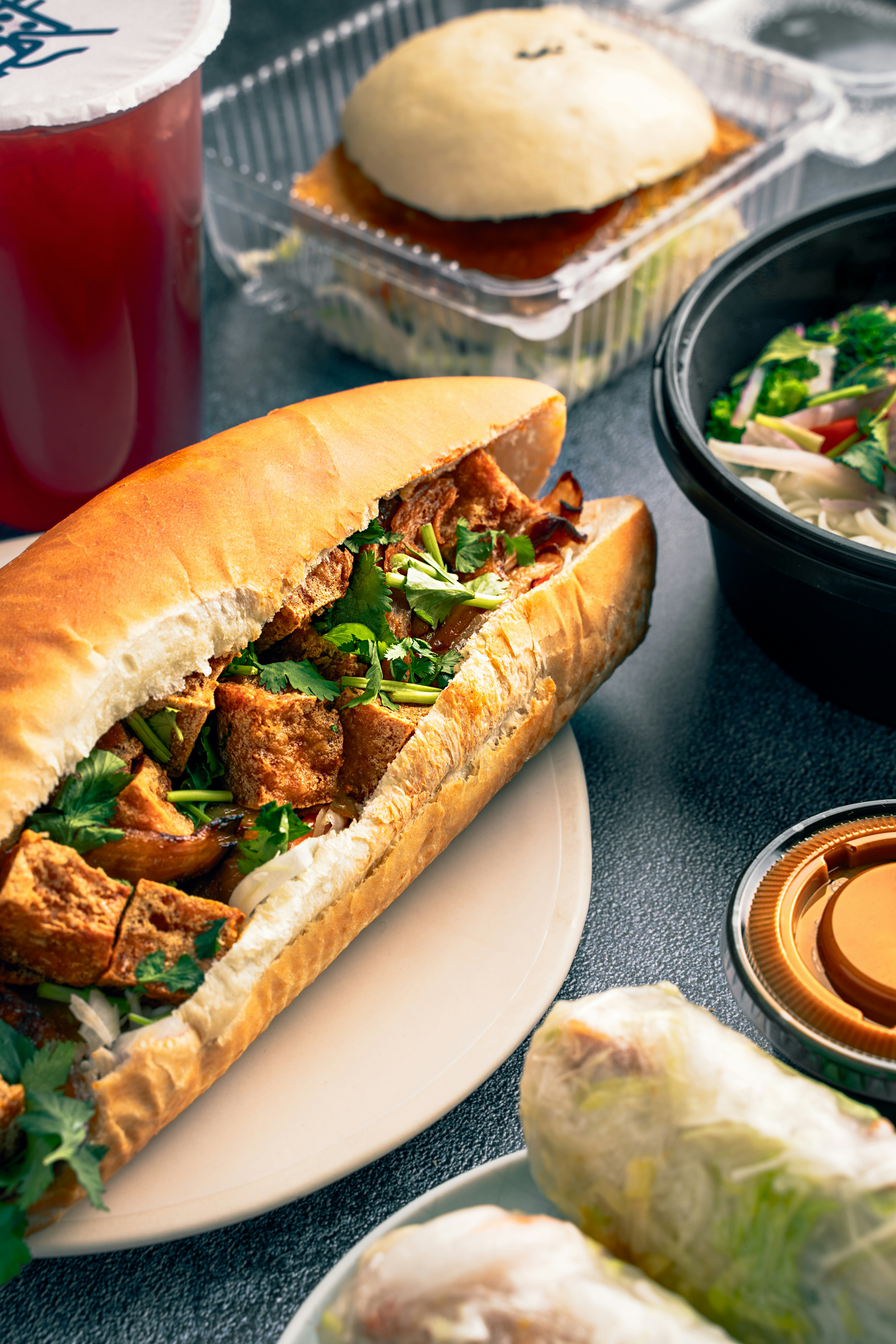 a sandwich with meat, lettuce, and sauce on a plate