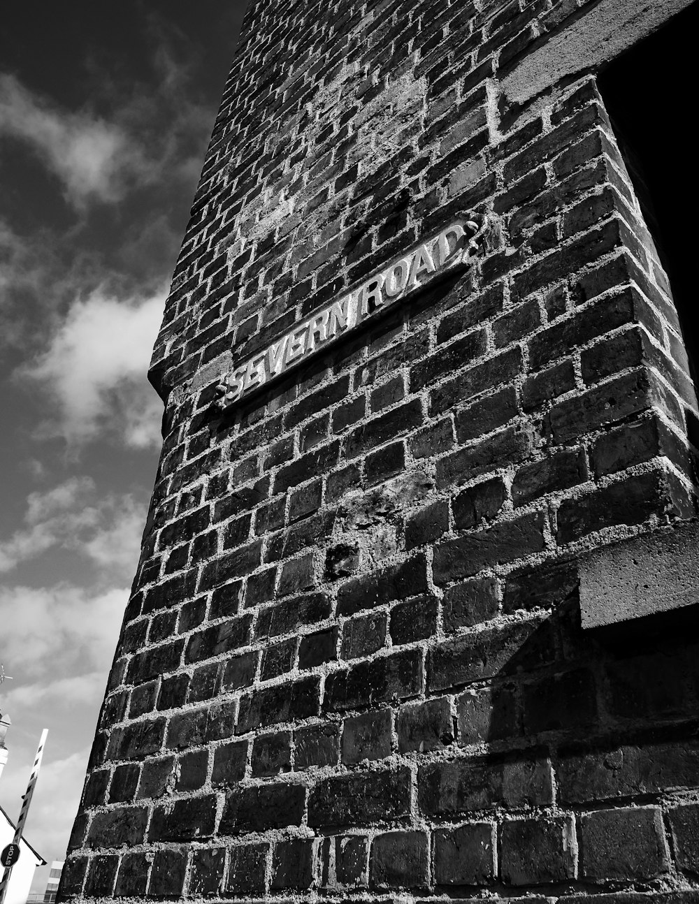 a black and white photo of a brick tower