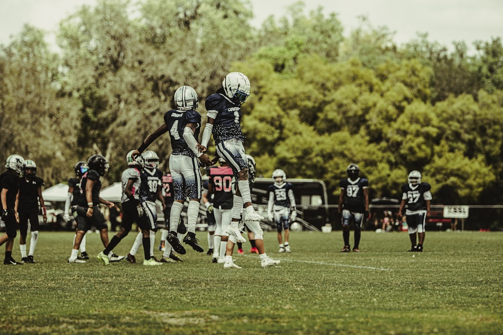 a group of football players standing on top of a field