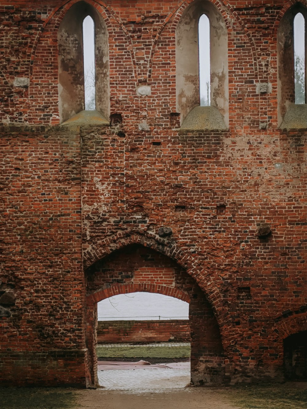 an old brick building with two arched windows