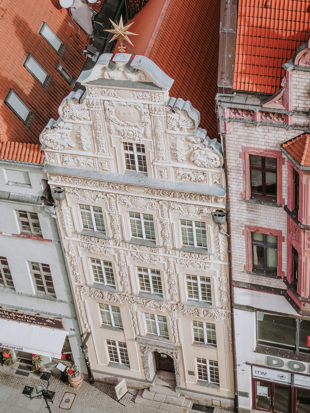 an aerial view of a building with a red roof