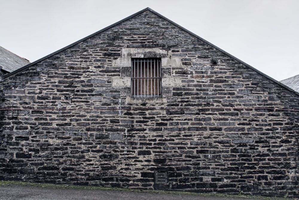 an old brick building with a barred window