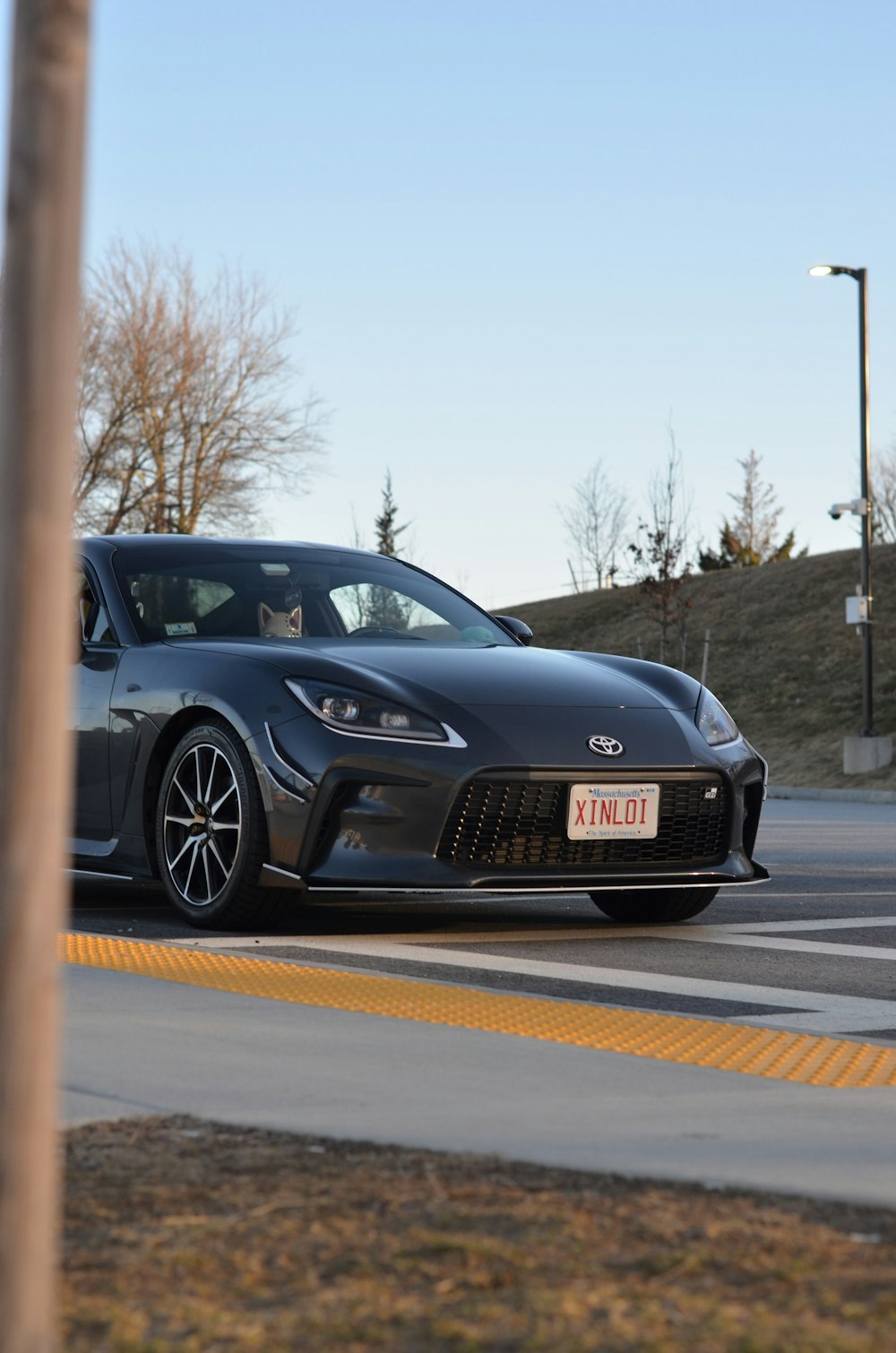 a black sports car driving down a street