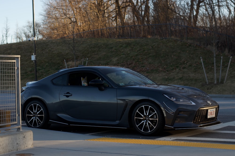 a gray sports car parked in a parking lot