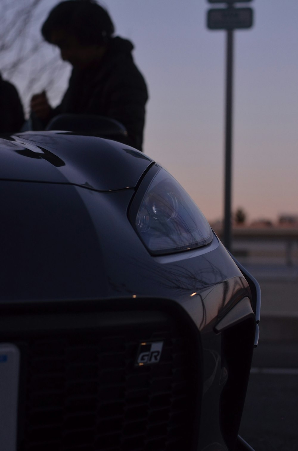 a car parked in a parking lot next to a street light