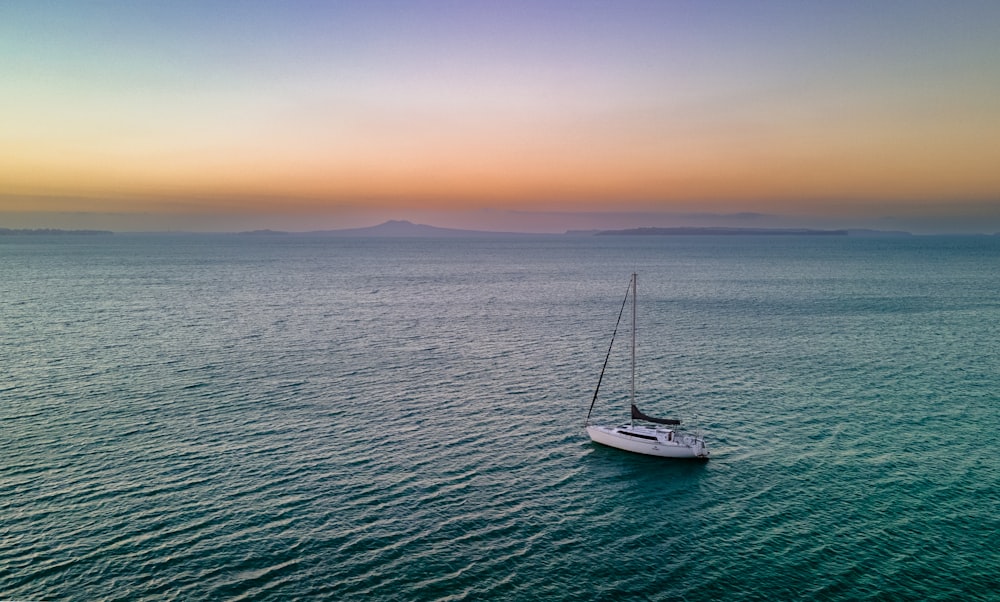 a sailboat floating in the middle of a large body of water