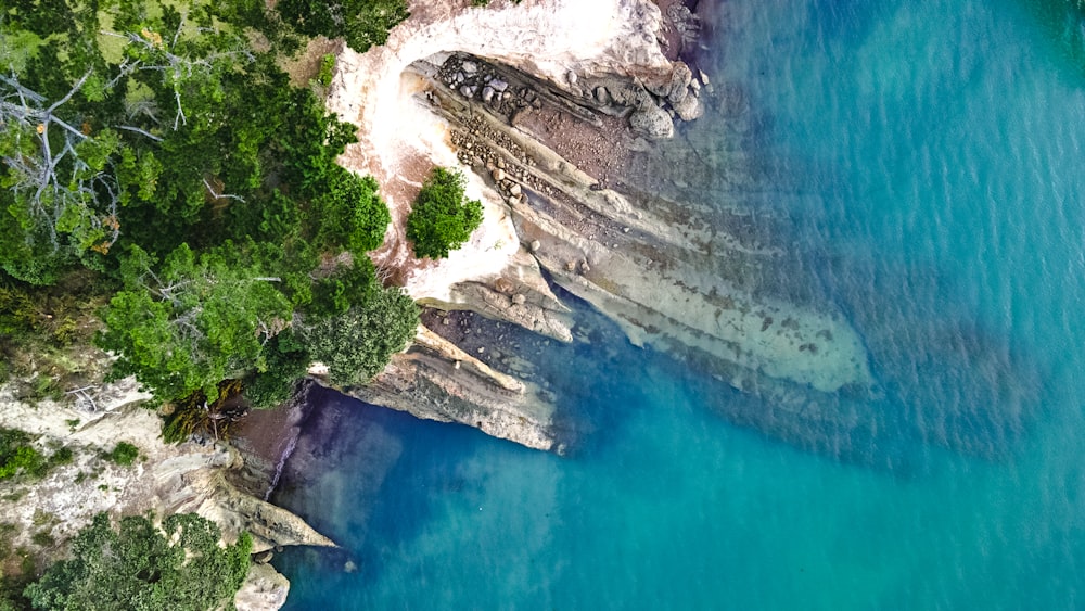 an aerial view of a body of water surrounded by trees