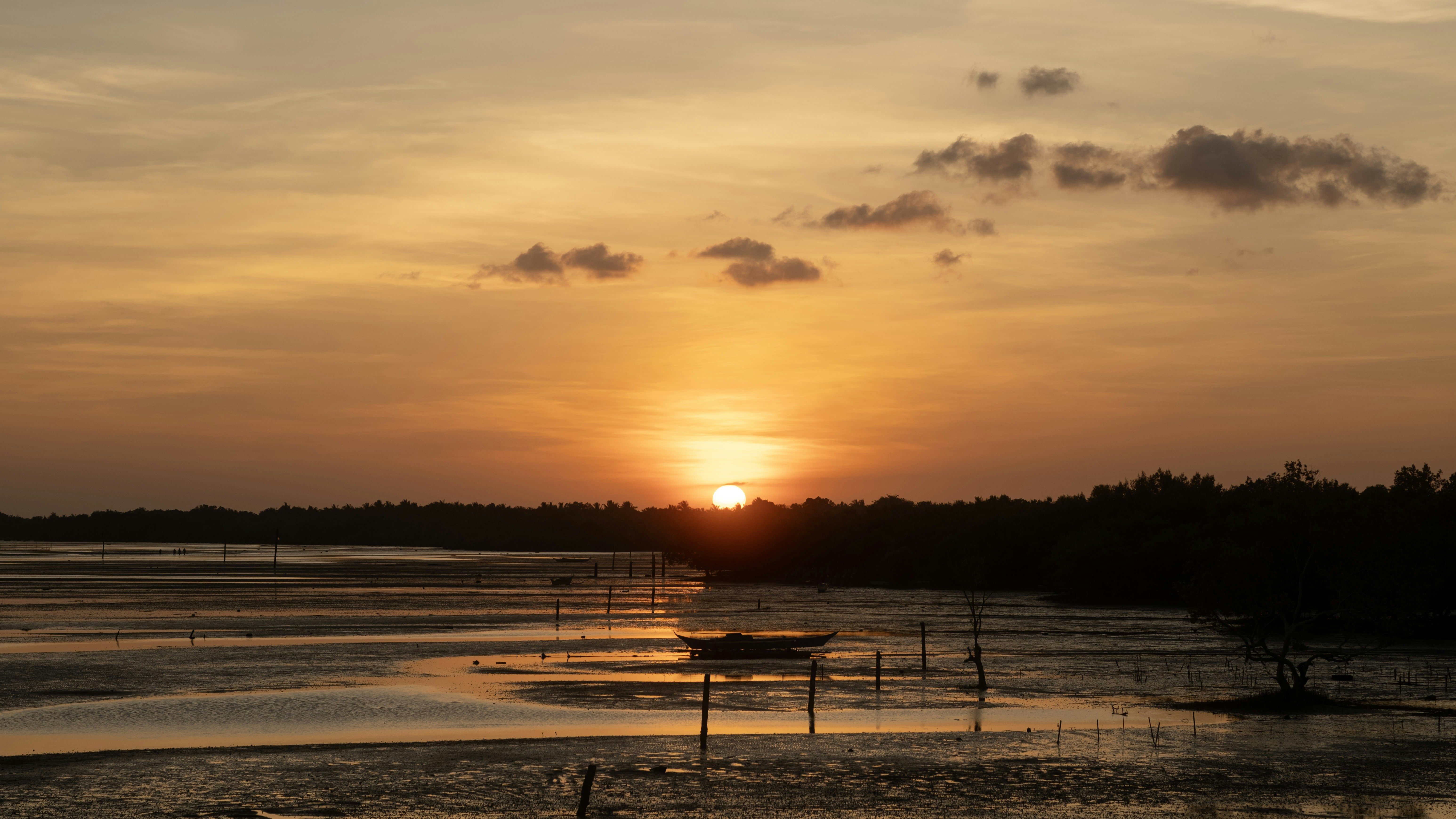 the sun is setting over a body of water