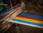a close up of a colorful weaving machine