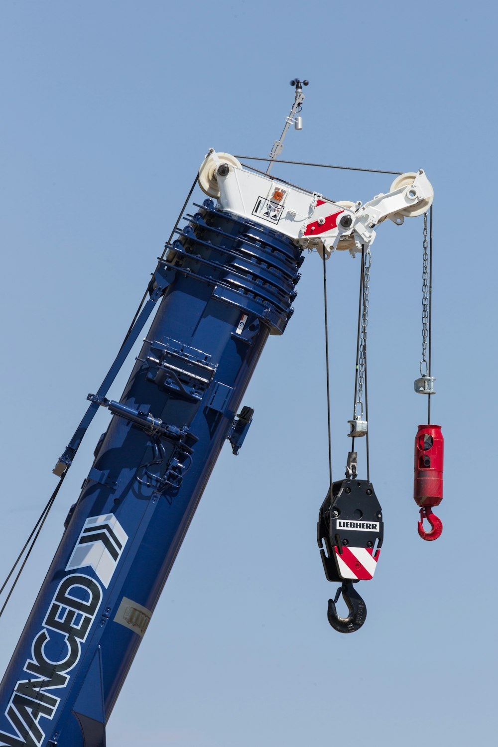 a crane is lifting a piece of equipment into the air