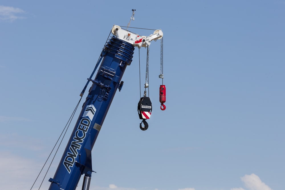 a crane is lifting a piece of equipment into the air
