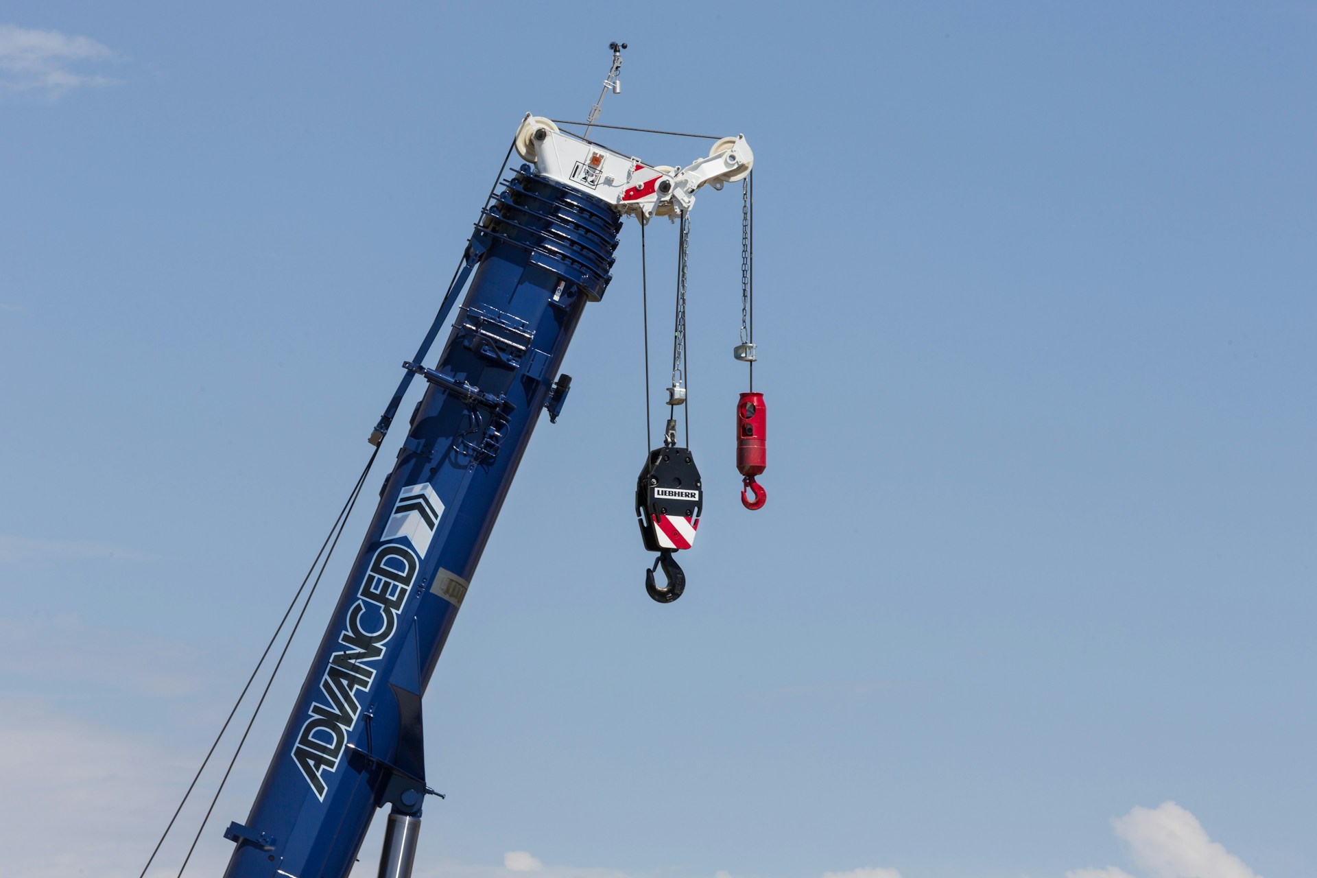 a crane is lifting a piece of equipment into the air
