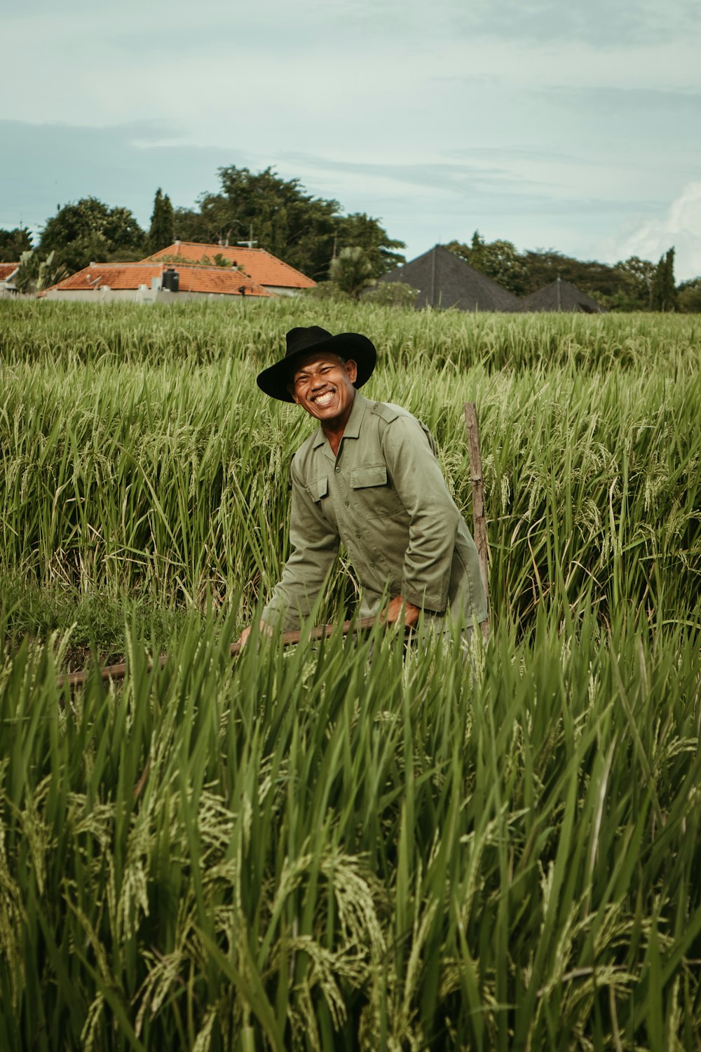 a man standing in a field of tall grass