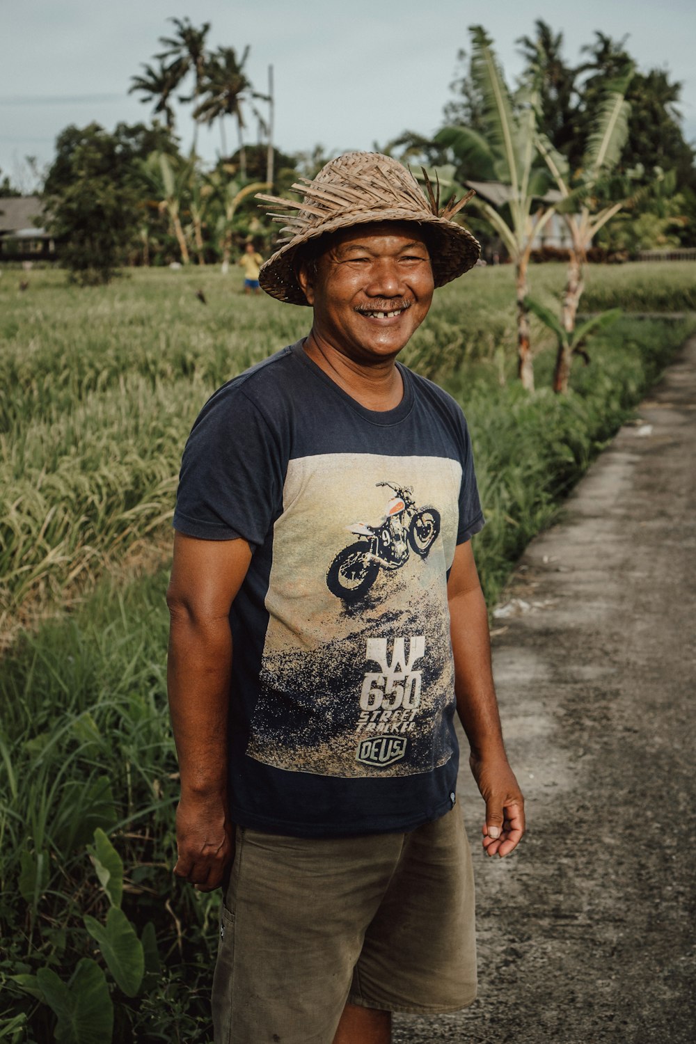 a man wearing a hat standing in a field