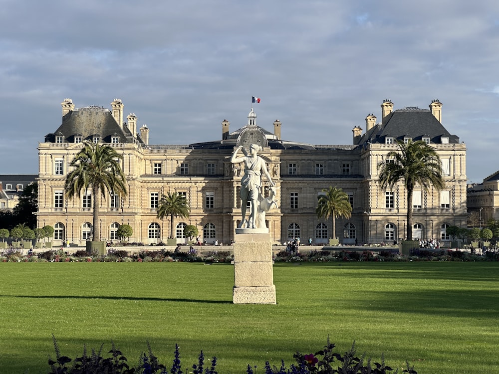 a large building with a statue in front of it