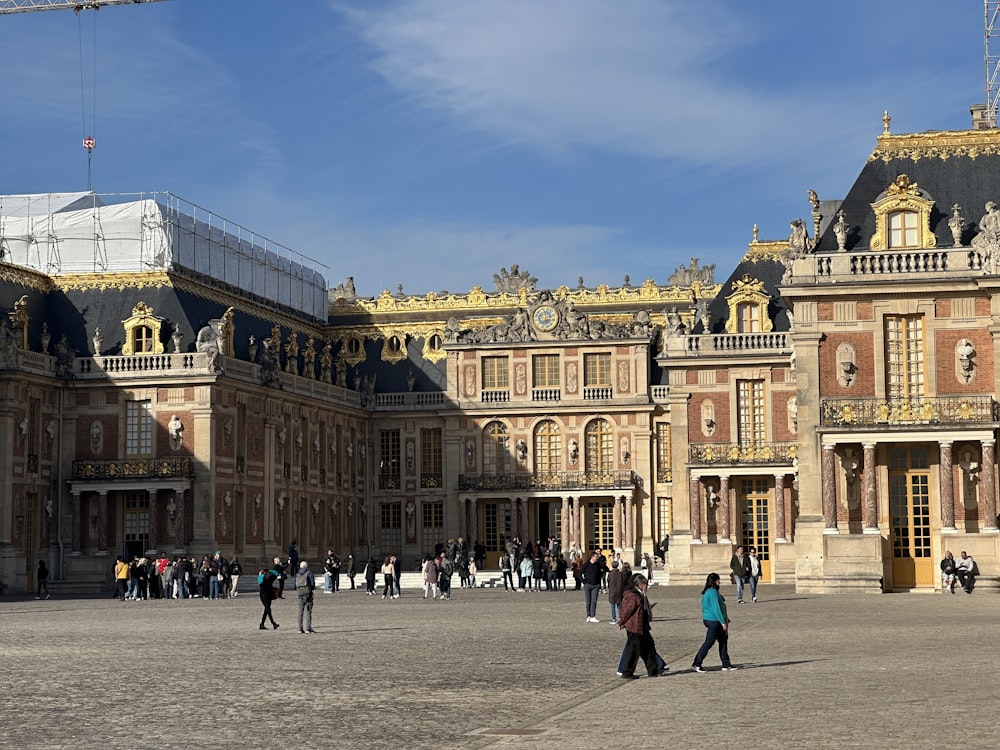 a group of people walking in front of a large building