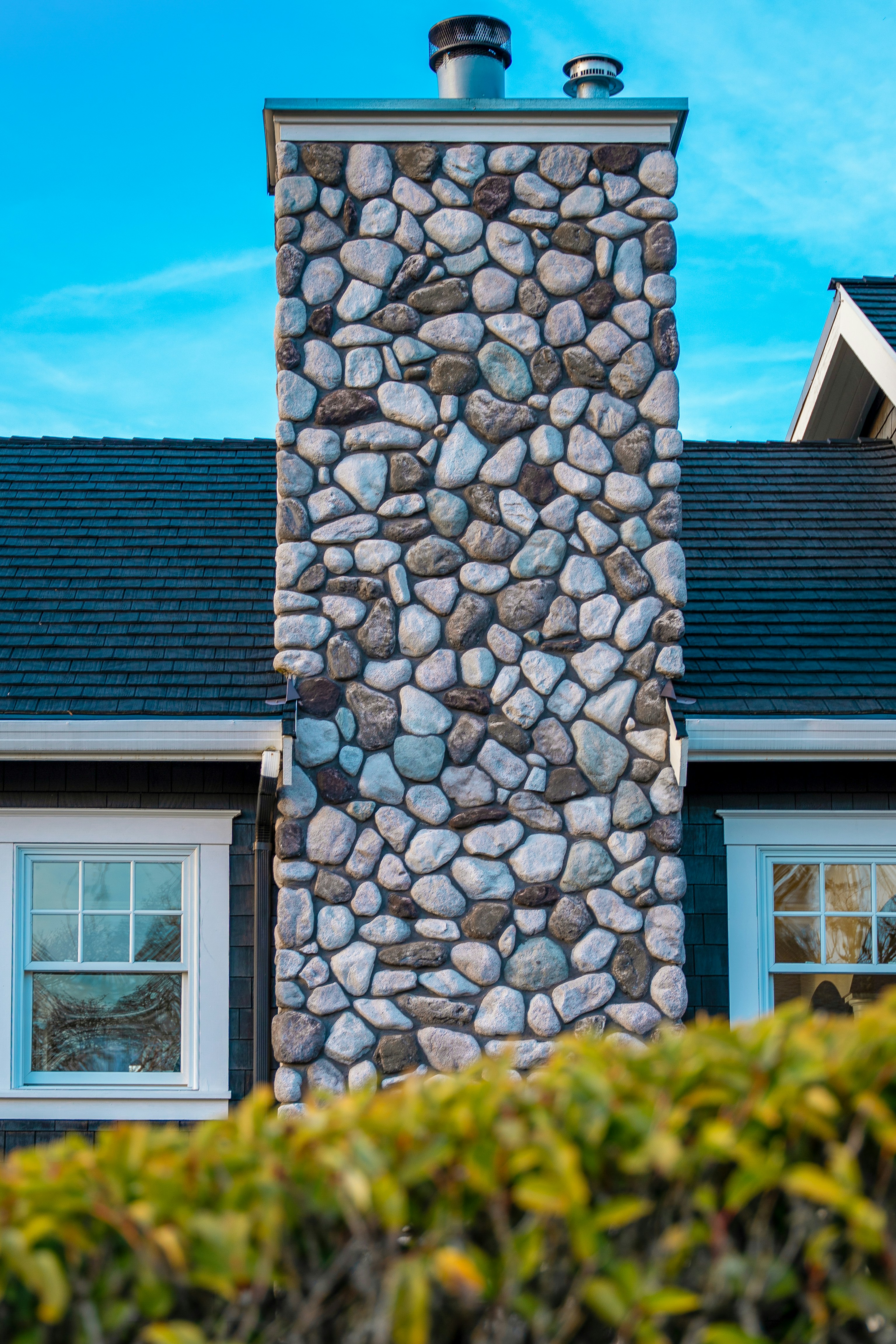 a stone building with a chimney on top of it