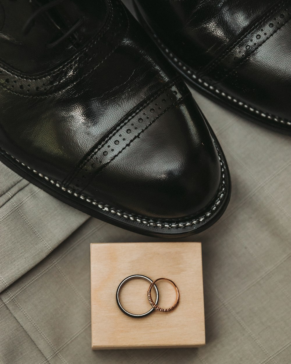 a couple of rings sitting on top of a wooden block