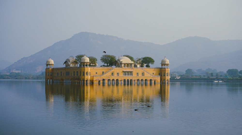 a large yellow building sitting on top of a lake