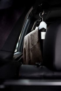 a coat hanging in the back of a car
