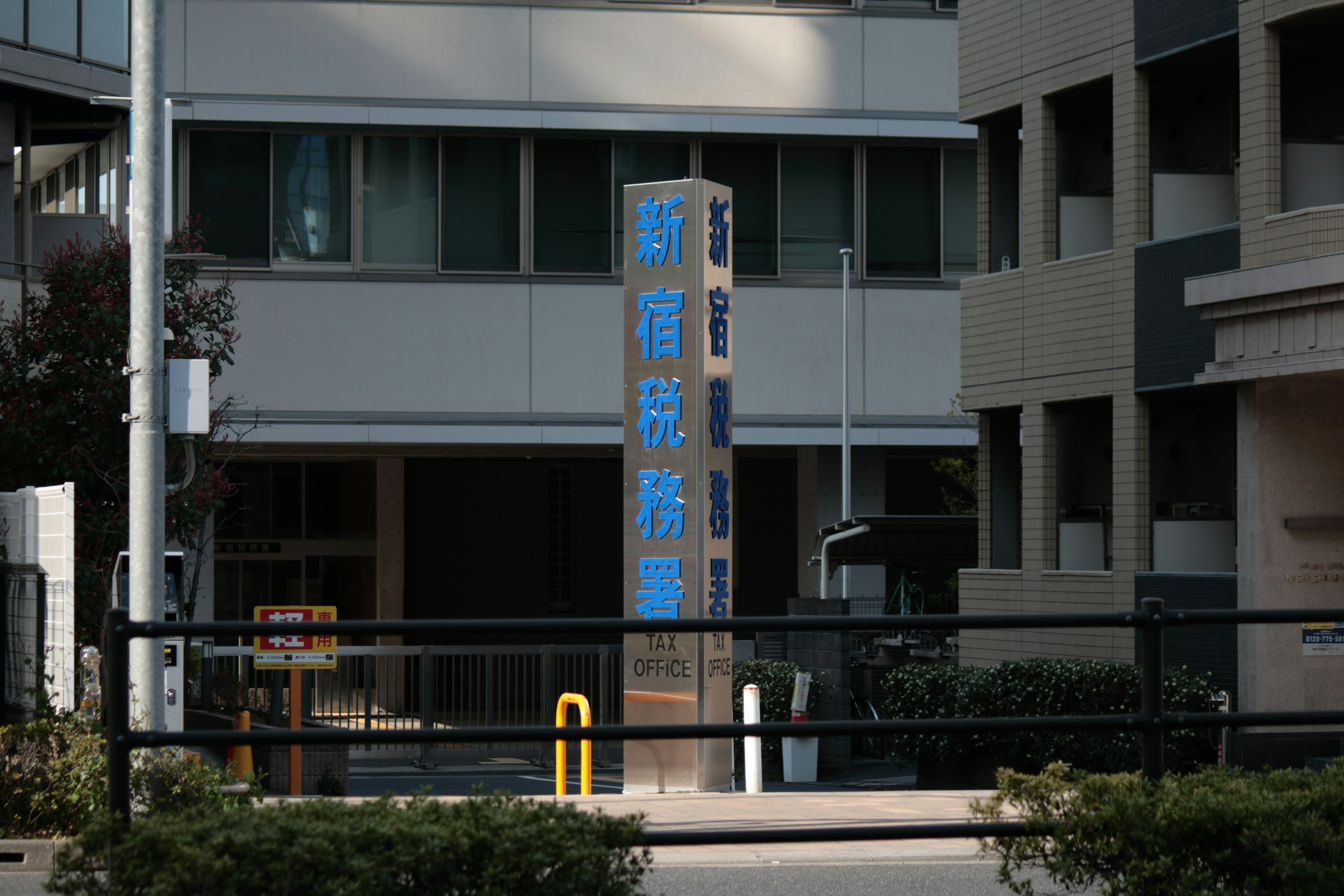 Modern government building with Japanese and English sign.