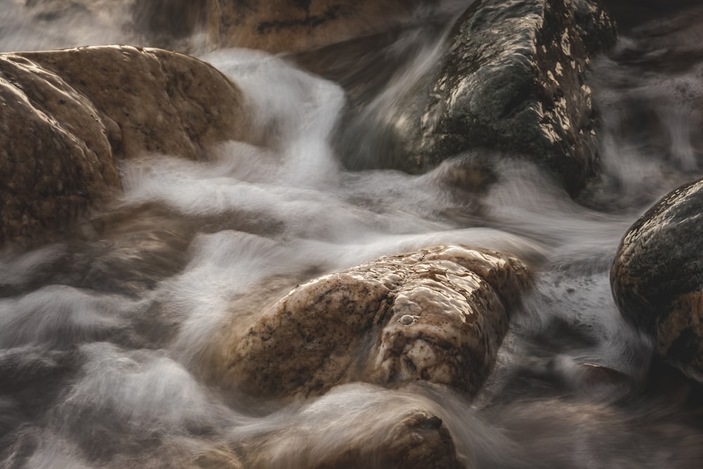 a stream of water running over rocks in a river