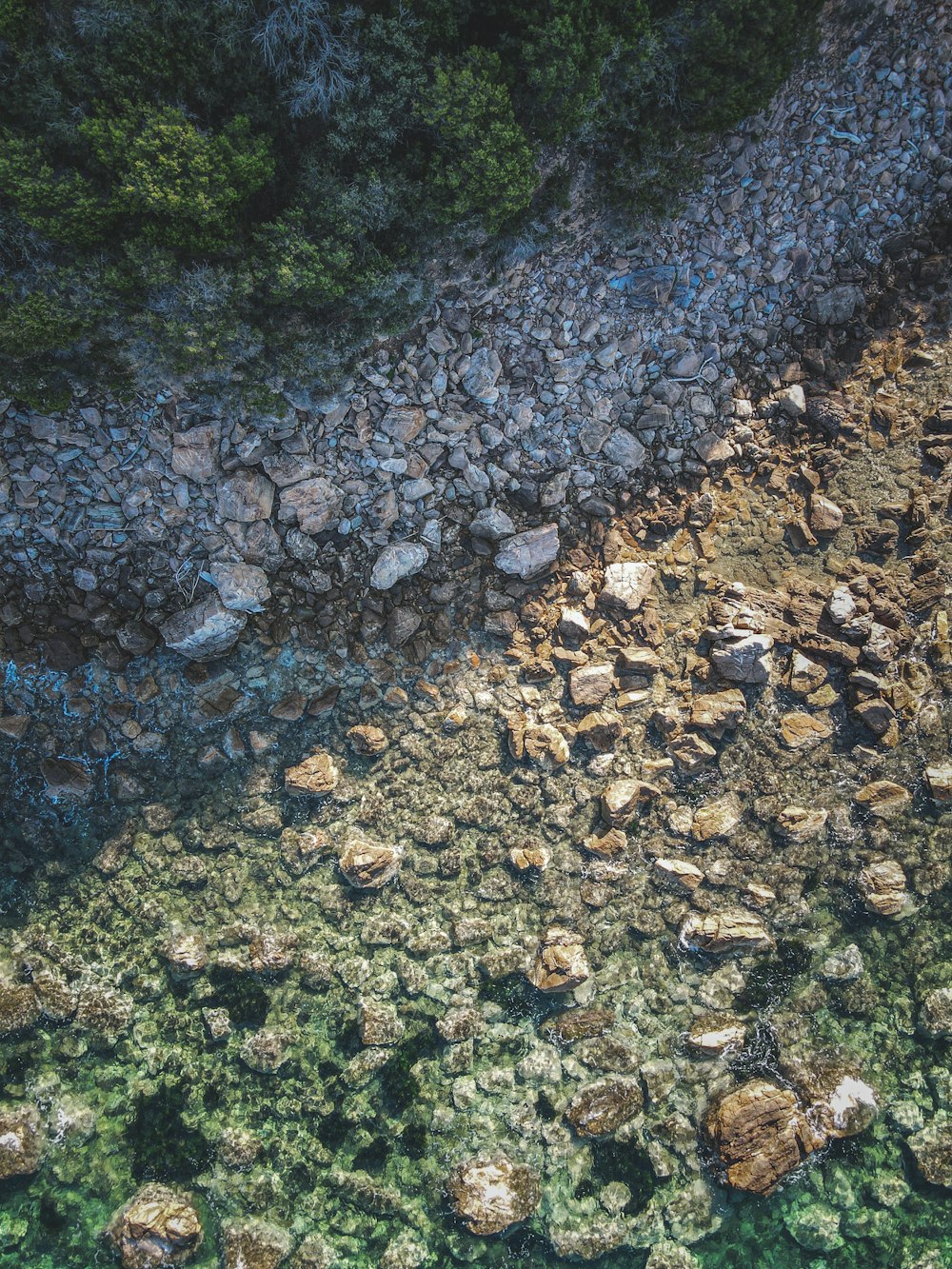 an aerial view of rocks and water