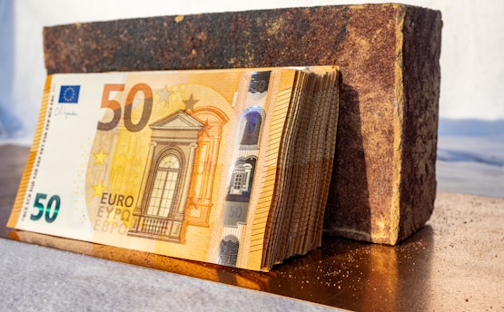 a stack of 50 euro bills sitting on top of a table