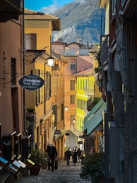 a group of people walking down a cobblestone street