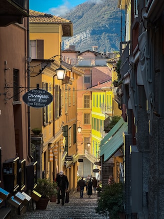 a group of people walking down a cobblestone street