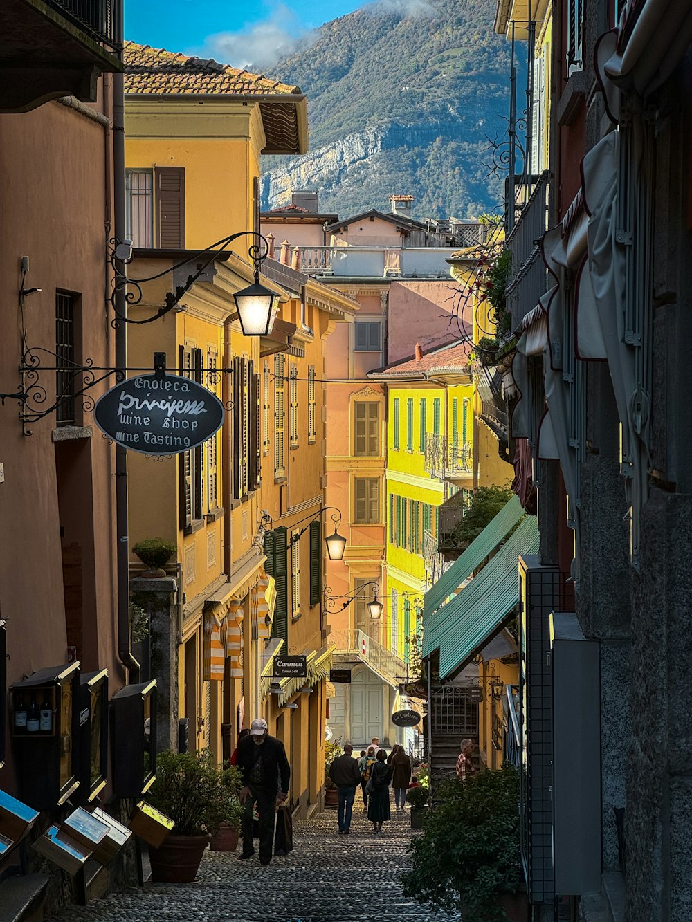 a group of people walking down a cobblestone street