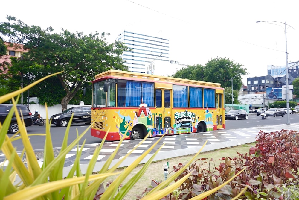 a yellow bus driving down a street next to tall buildings