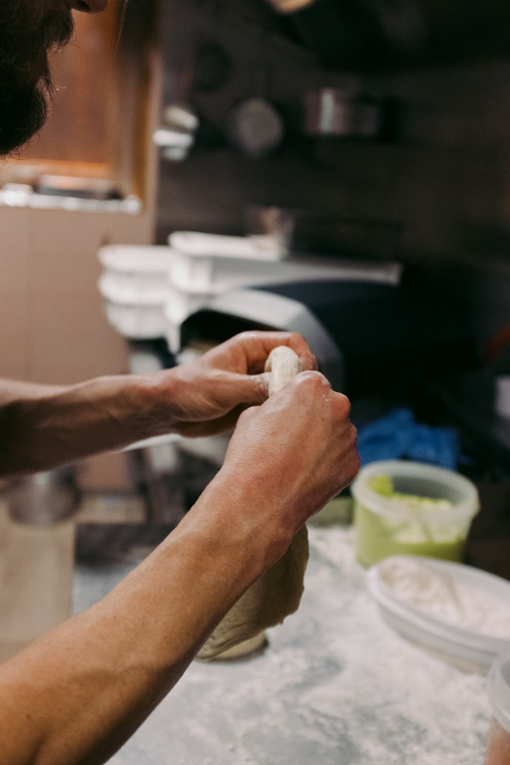 a man is kneading dough into a bowl
