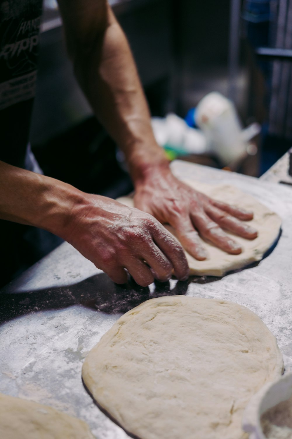 a person is kneading dough on a table