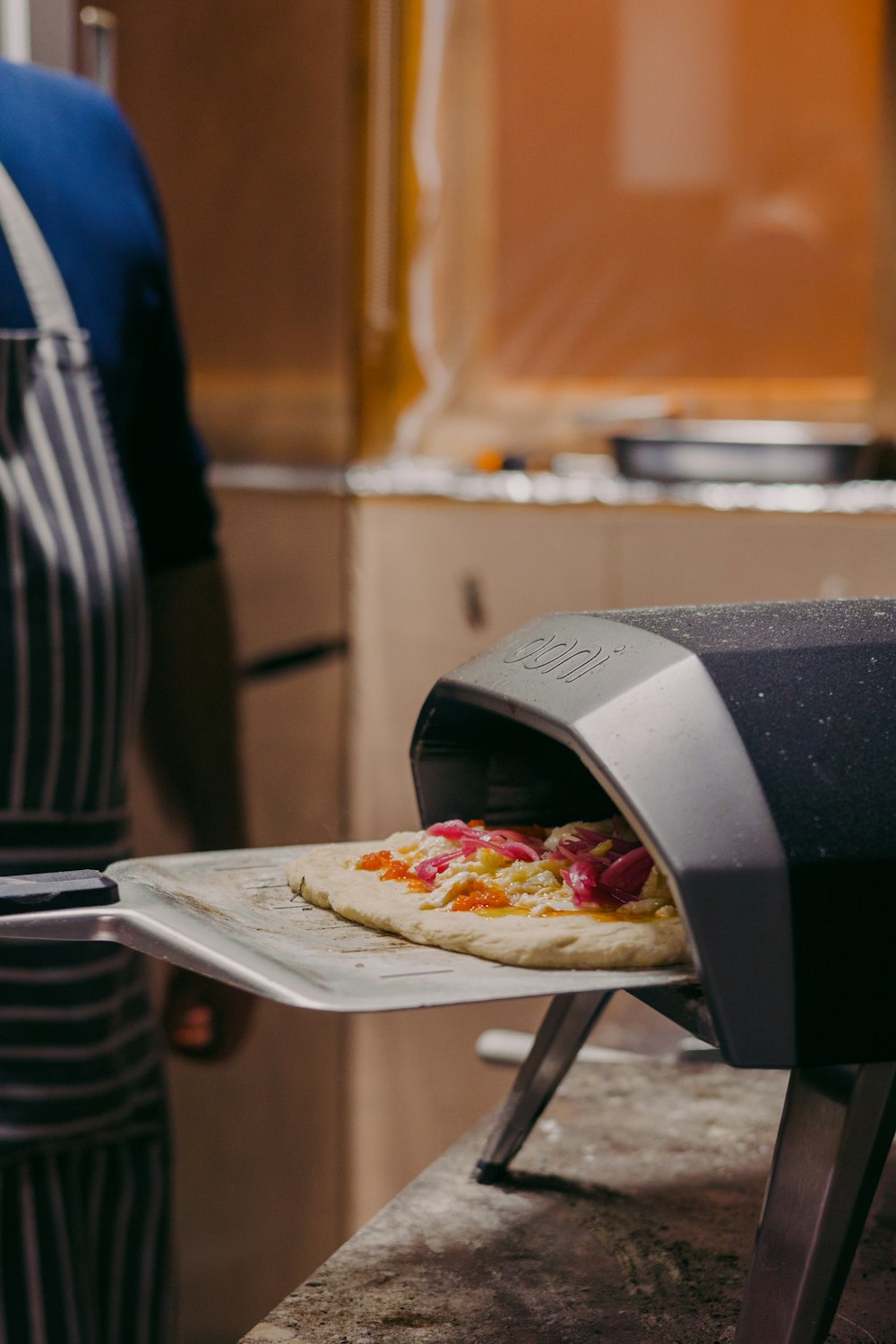 a pizza being cooked in a pizza oven