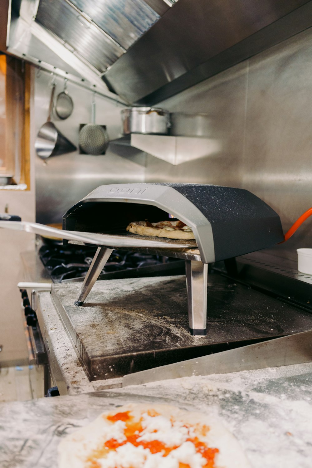 a pizza sitting on top of a pizza oven