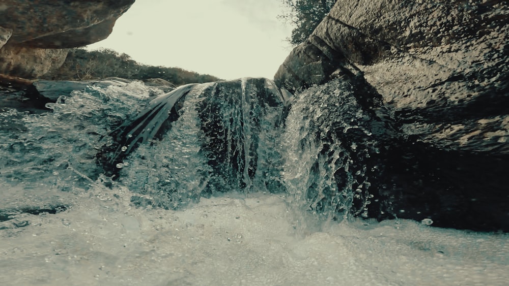 a small waterfall flowing into a pool of water