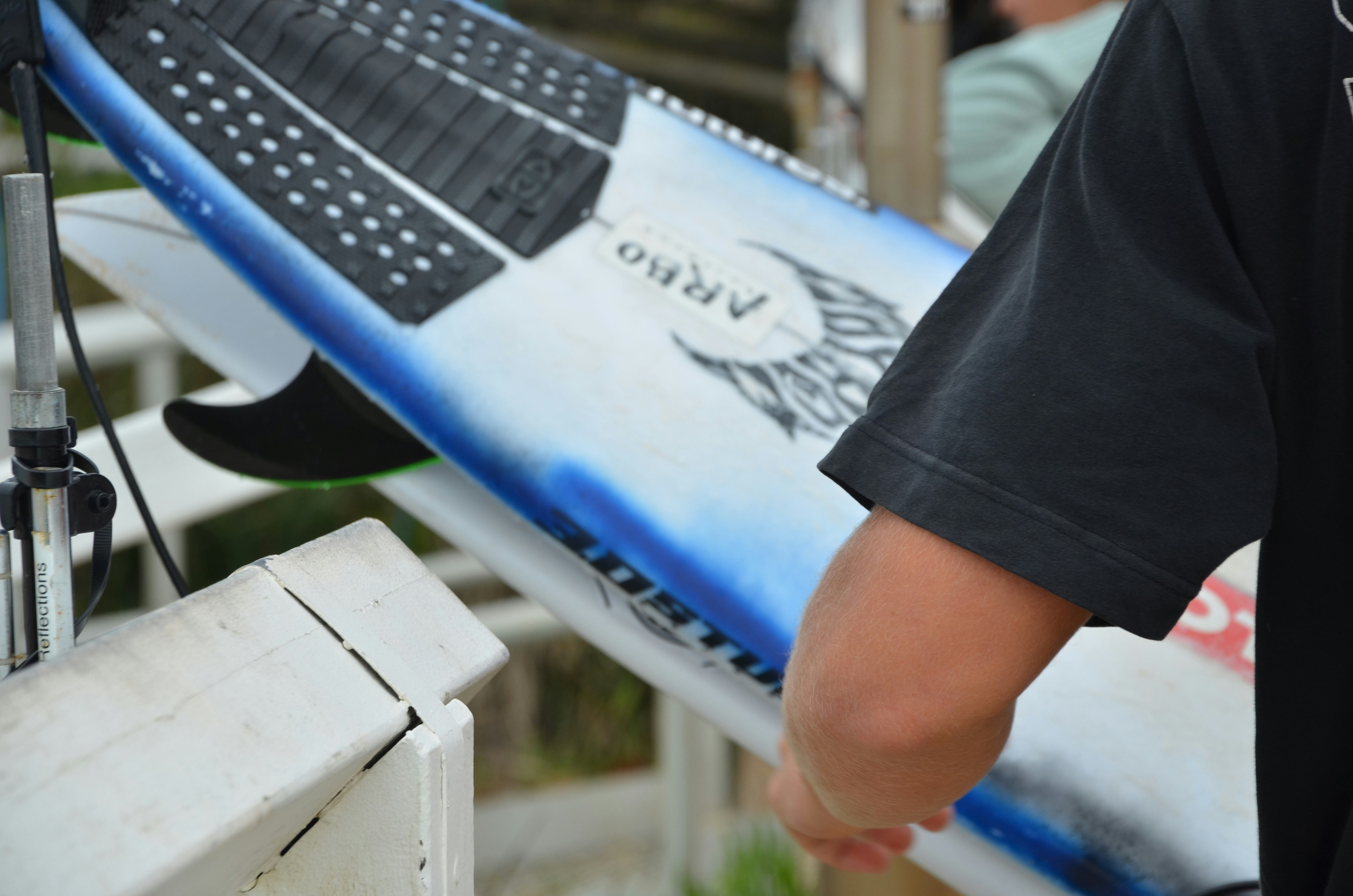 a close up of a person holding a surfboard