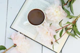 a cup of coffee sitting on top of a book