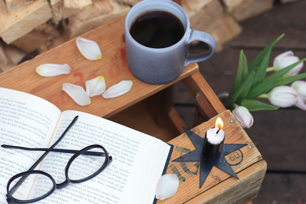 a cup of coffee and a book on a table