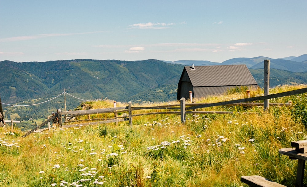 a house on a hill with mountains in the background